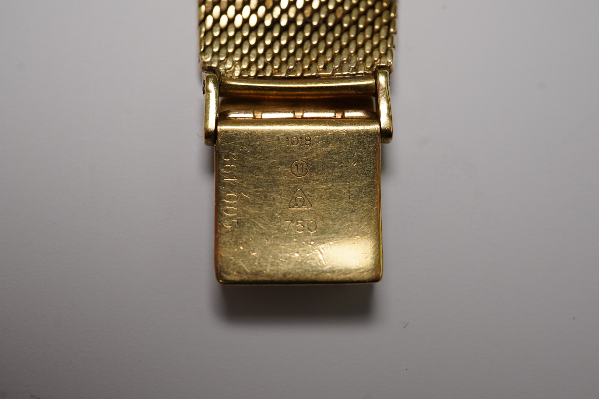 A gentleman's early 1960's 18ct gold Omega De Ville automatic dress wrist watch, on integral Omega 18ct gold mesh link bracelet